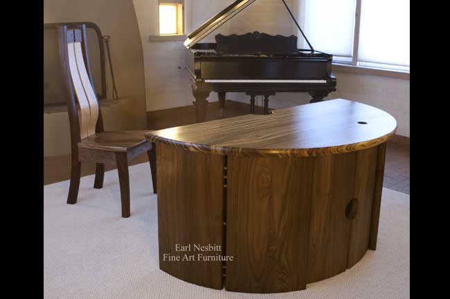custom made executive desk with matching chair showing zebrawood top and walnut base